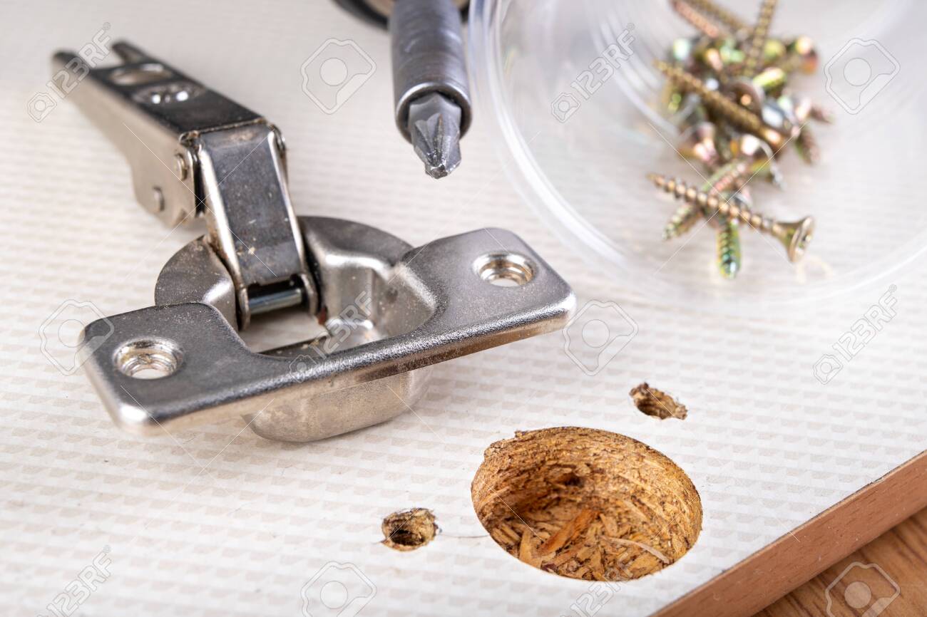 Installation Of Furniture Hinges In The Kitchen Cabinet Door Stock Photo Picture And Royalty Free Image Image 135335325