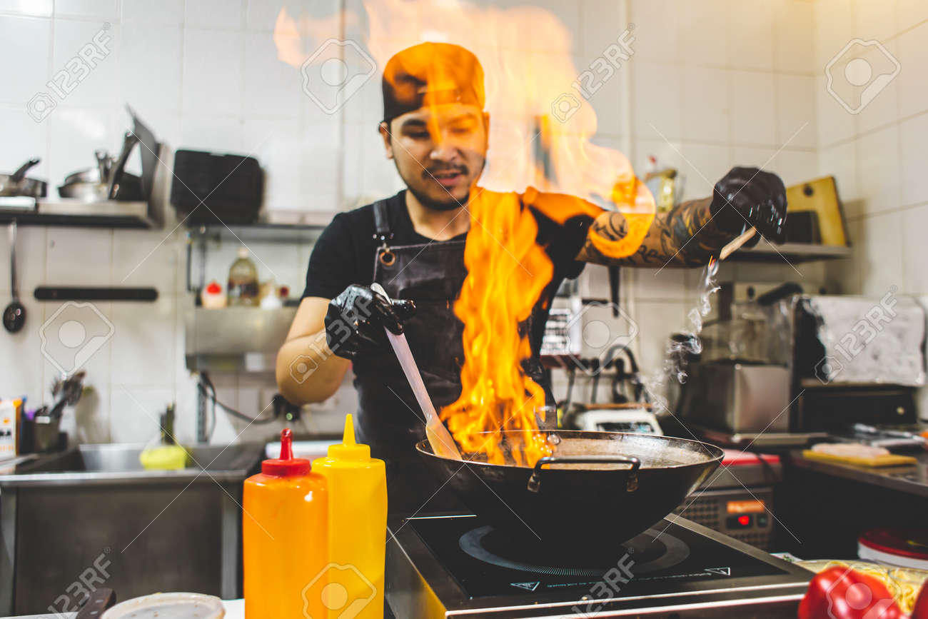 street food. fried noodles in a wok with chicken and shrimp on the open fire - 171606171 street food. fried noodles in a wok with chicken and shrimp on the open fire - 171606171