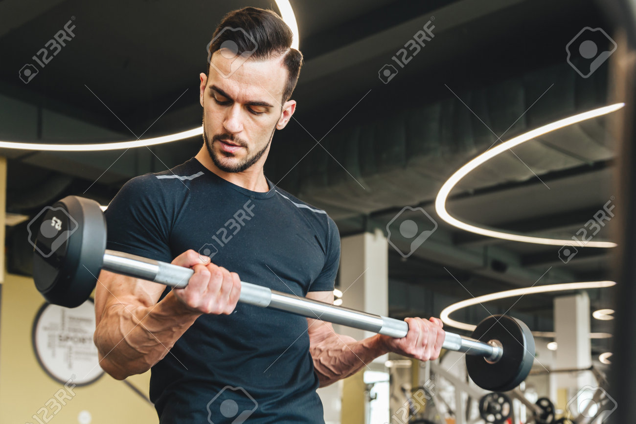 Handsome young sporty male bodybuilder doing barbell exercise in gym - 171606177 Handsome young sporty male bodybuilder doing barbell exercise in gym - 171606177