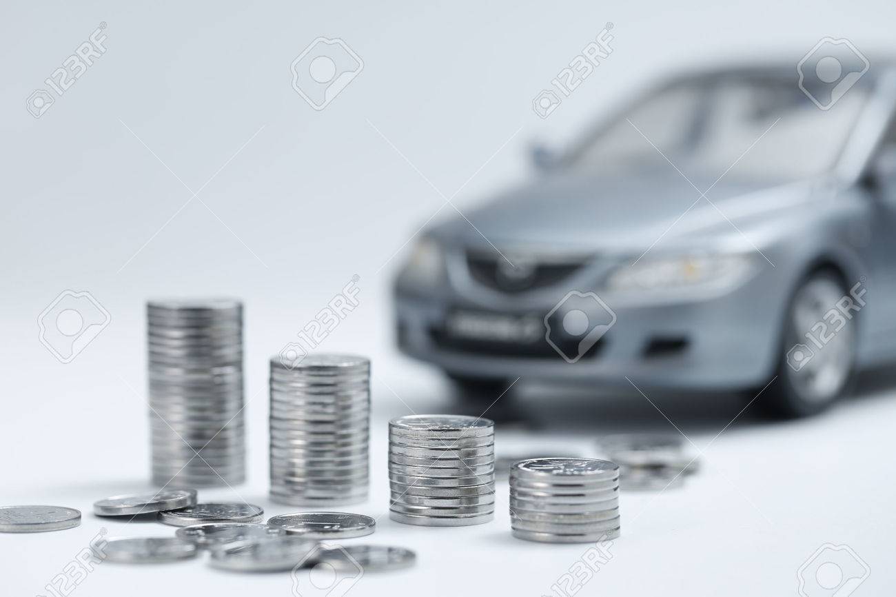coin stacks in front of car - 67335416 coin stacks in front of car - 67335416