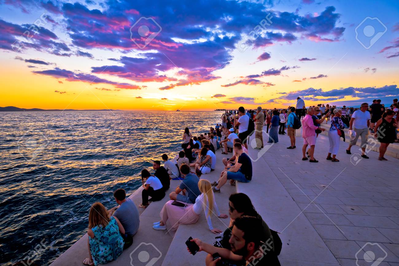 ZADAR, CROATIA - July 18 2017: Unidentified people on Zadar sea organs at sunset. Many tourists visits unique architectural object located on Zadar waterfront - musical instrument powered by the sea streams. - 95345654 ZADAR, CROATIA - July 18 2017: Unidentified people on Zadar sea organs at sunset. Many tourists visits unique architectural object located on Zadar waterfront - musical instrument powered by the sea streams. - 95345654