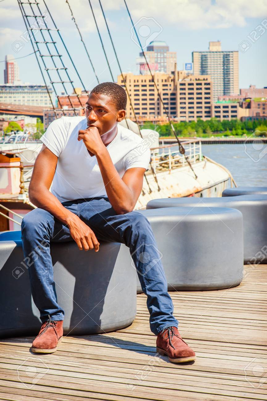 Young African American Man traveling in New York, wearing white..