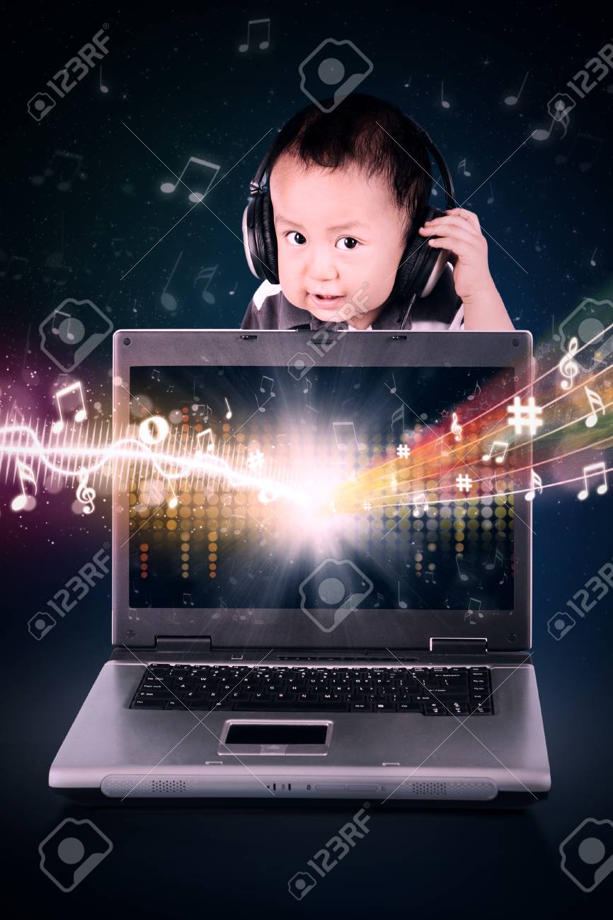 男の子がノート パソコンの画面から飛んで音符で音楽を聴く の写真素材 画像素材 Image