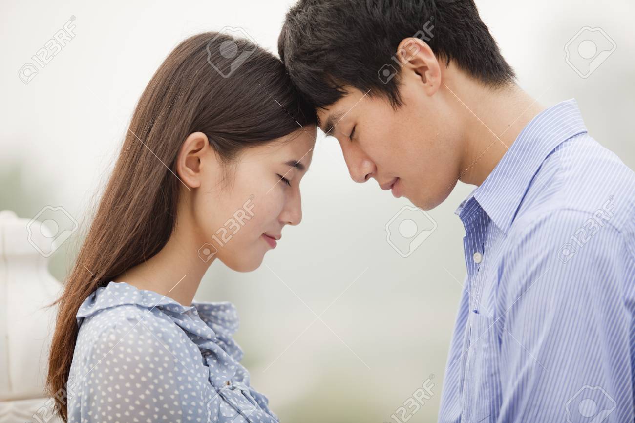 Young couple touching foreheads - 35988337.