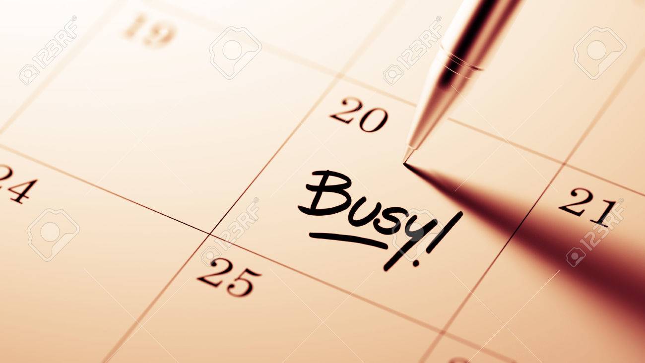 Closeup Of A Personal Agenda Setting An Important Date Written With Pen The Words Busy Written On A White Notebook To Remind You An Important Appointment Stock Photo Picture And Royalty Free