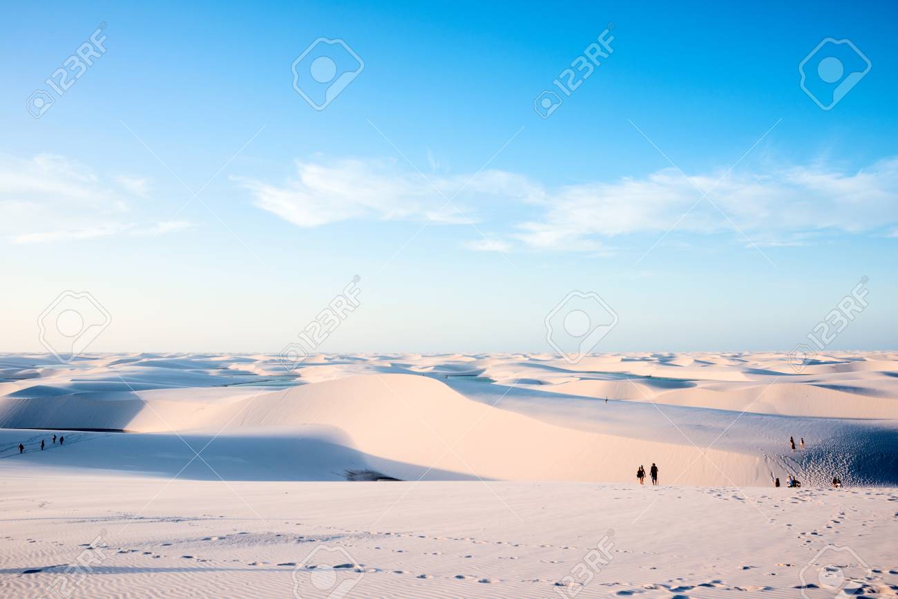 Lencois Maranhenses,Brazil, July 13, 2016 - Tourists are saying goodbye to the sun from Sand dunes with blue and green lagoons in Lencois Maranhenses National Park - 83579775 Lencois Maranhenses,Brazil, July 13, 2016 - Tourists are saying goodbye to the sun from Sand dunes with blue and green lagoons in Lencois Maranhenses National Park - 83579775