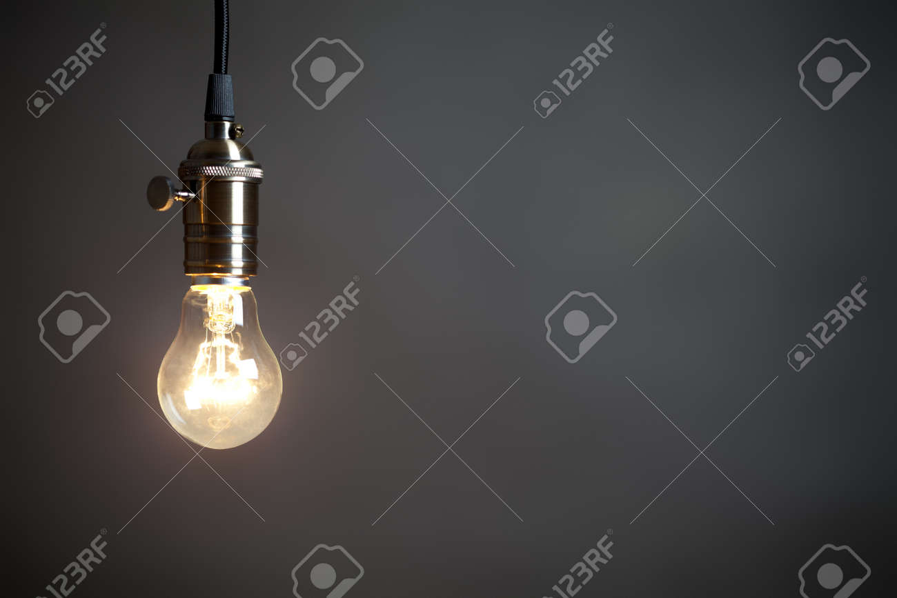 Vintage incandescent light bulb on gray background. On right is empty space to put text or something else. This file is cleaned and retouched. - 165287119 Vintage incandescent light bulb on gray background. On right is empty space to put text or something else. This file is cleaned and retouched. - 165287119