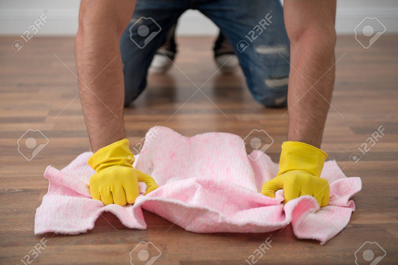 Selected Focus On The Hands Of Janitor Wearing Yellow Rubber