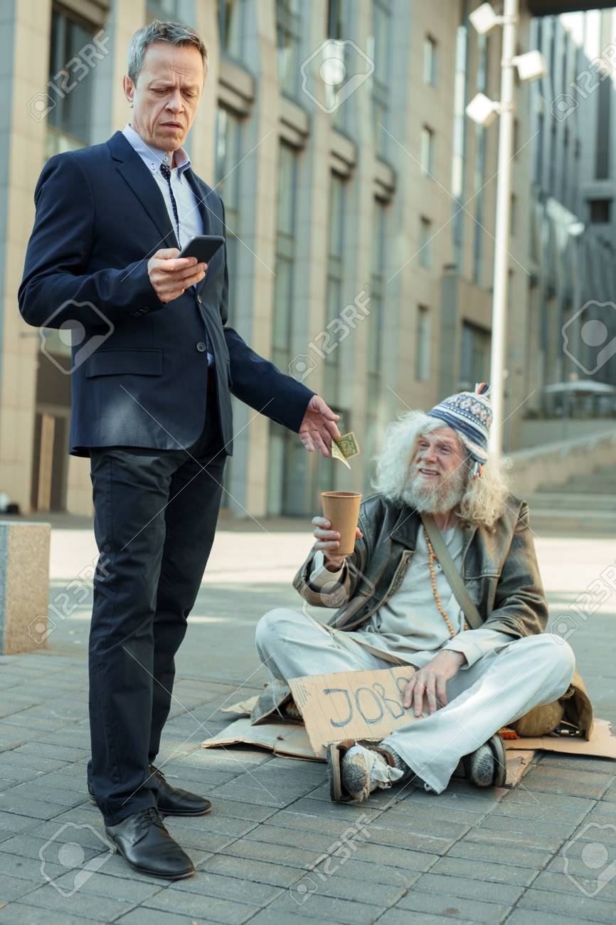 Rich And Poor. Elderly Rich Successful Businessman Feeling Helpful While  Giving Some Money To Poor Man Stock Photo, Picture and Royalty Free Image.  Image 103544749., image size:866x1300