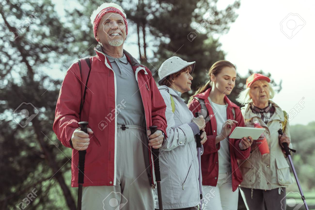 Amateur Tourists Hiking In Mountains