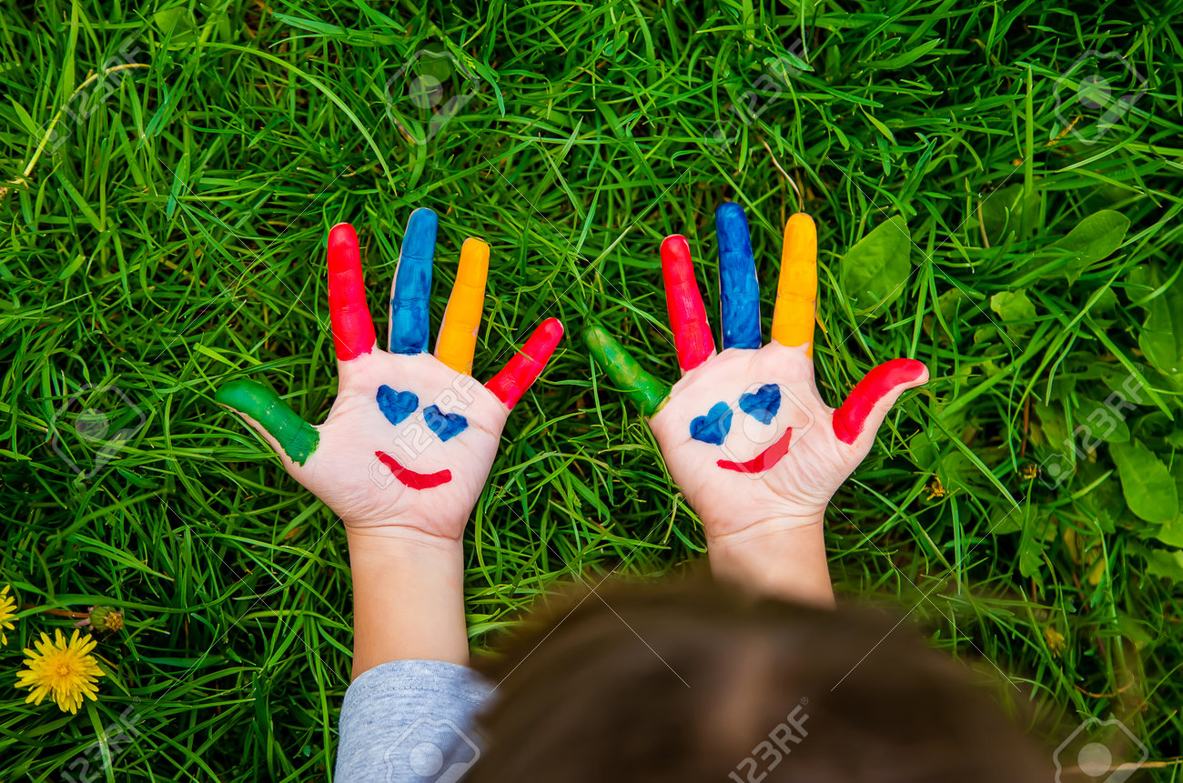 Smile on the hands of a child drawing. Selective focus. Kid. - 169160239 Smile on the hands of a child drawing. Selective focus. Kid. - 169160239