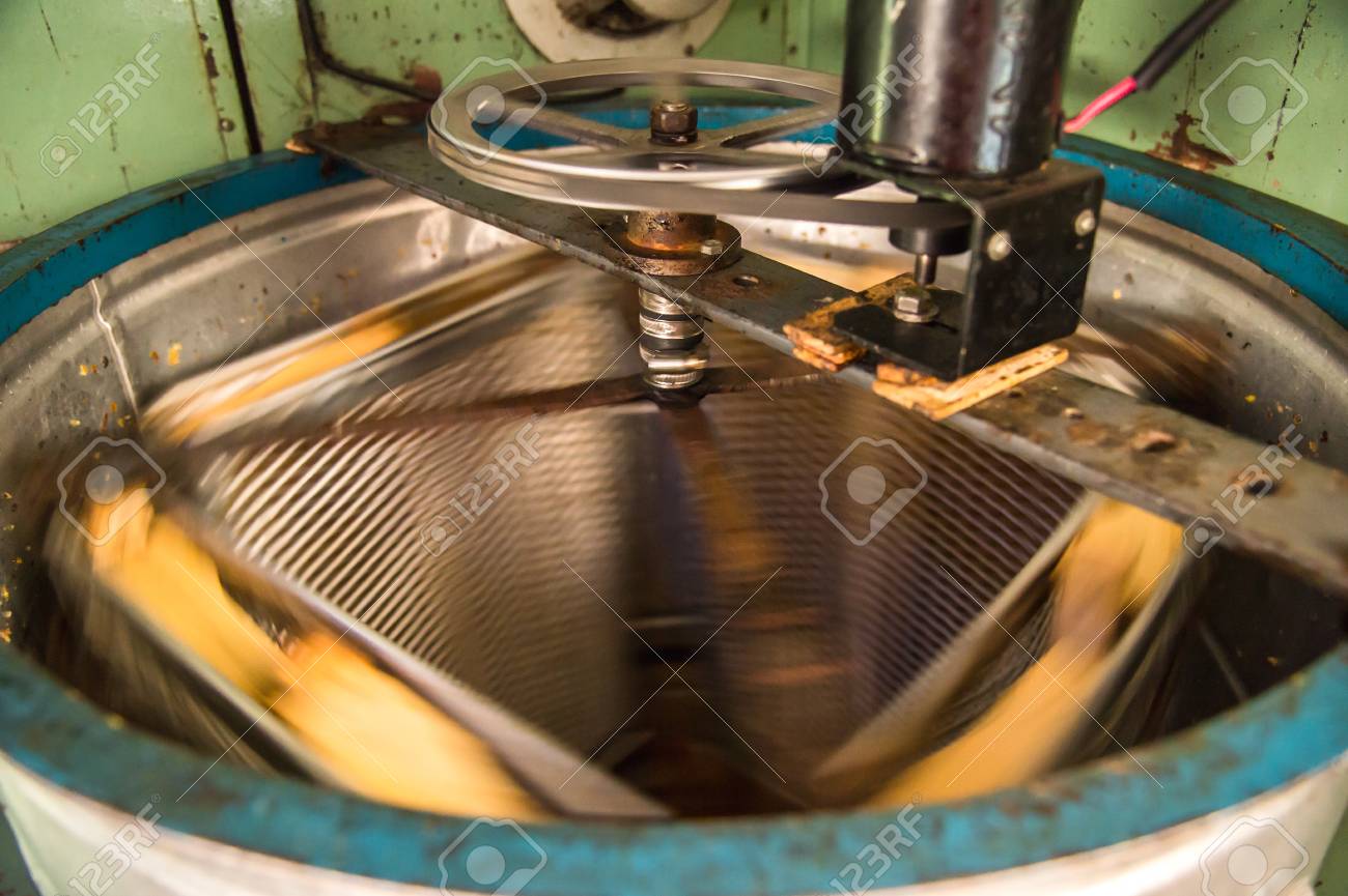 old hand made automated honey extractor stock photo picture and
