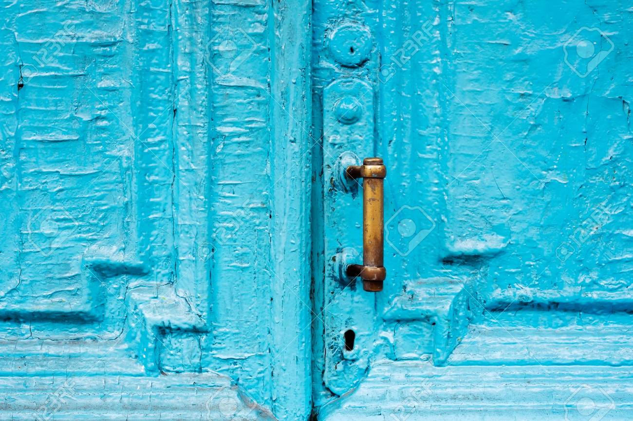 Close-up keyholes with curtains and a handle on the blue many times painted cracked double-barreled wooden vintage door of the last century with a post slit. - 95804251 Close-up keyholes with curtains and a handle on the blue many times painted cracked double-barreled wooden vintage door of the last century with a post slit. - 95804251