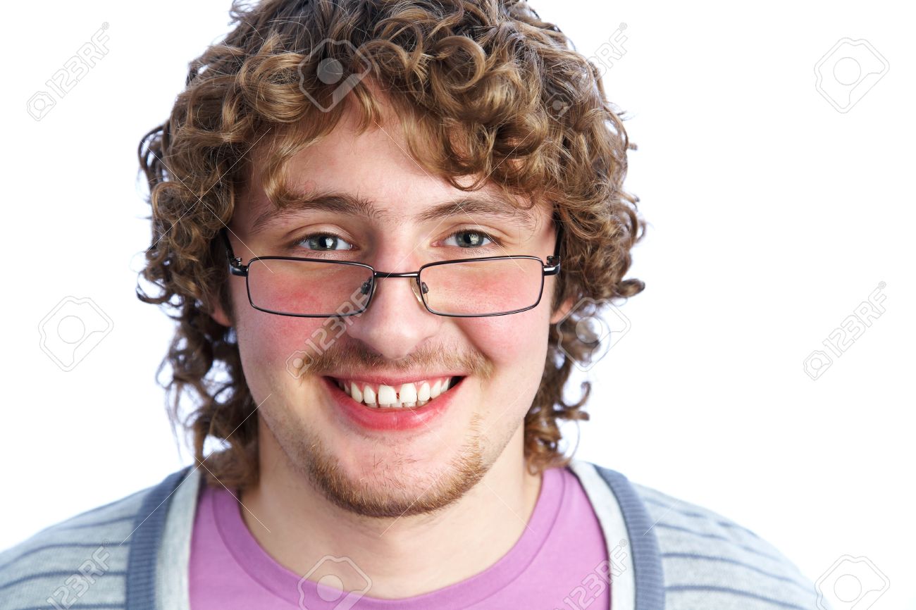 Portrait Of A Handsome Young Man In Glasses With Curly Hair