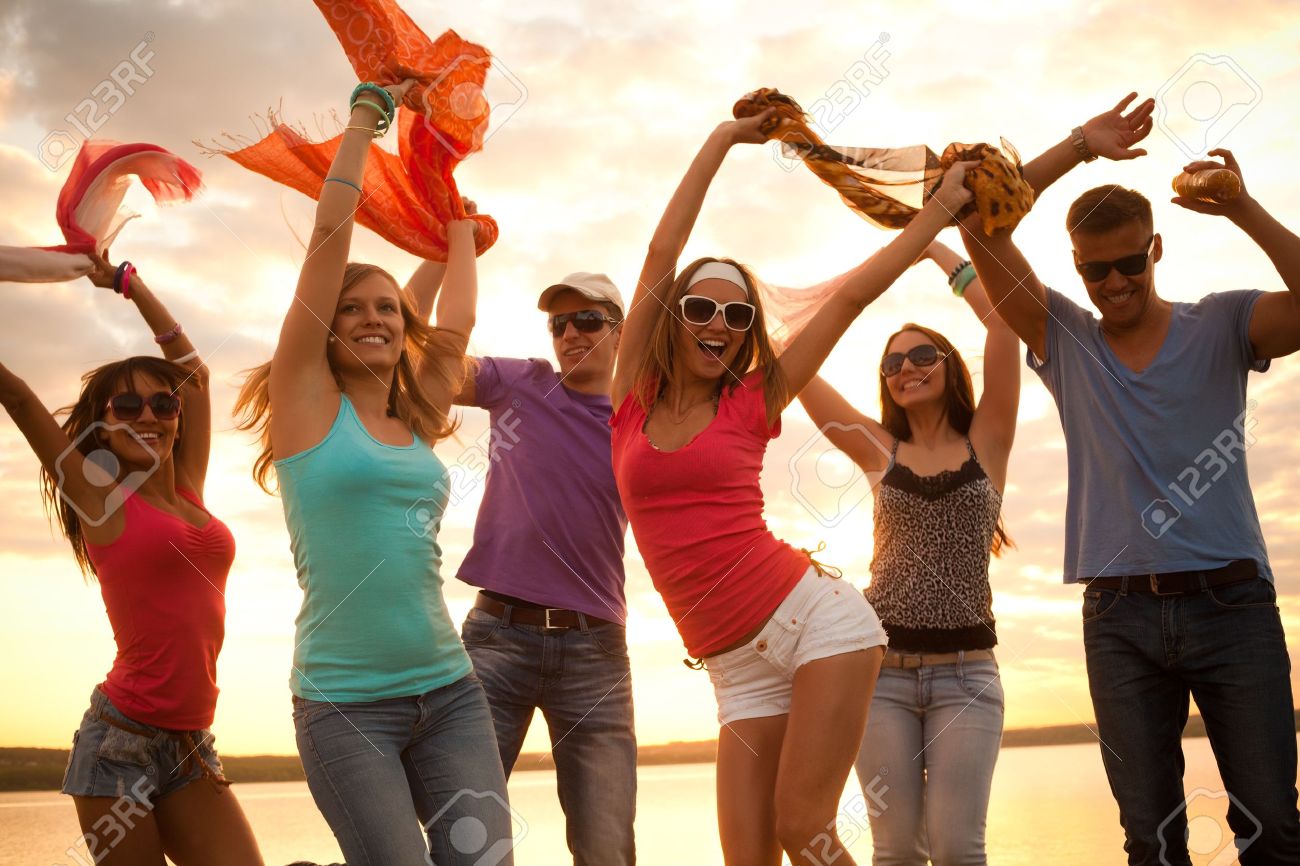 Large Group Of Young People Enjoying A Beach Party Stock Photo, Picture And  Royalty Free Image. Image 21116806.