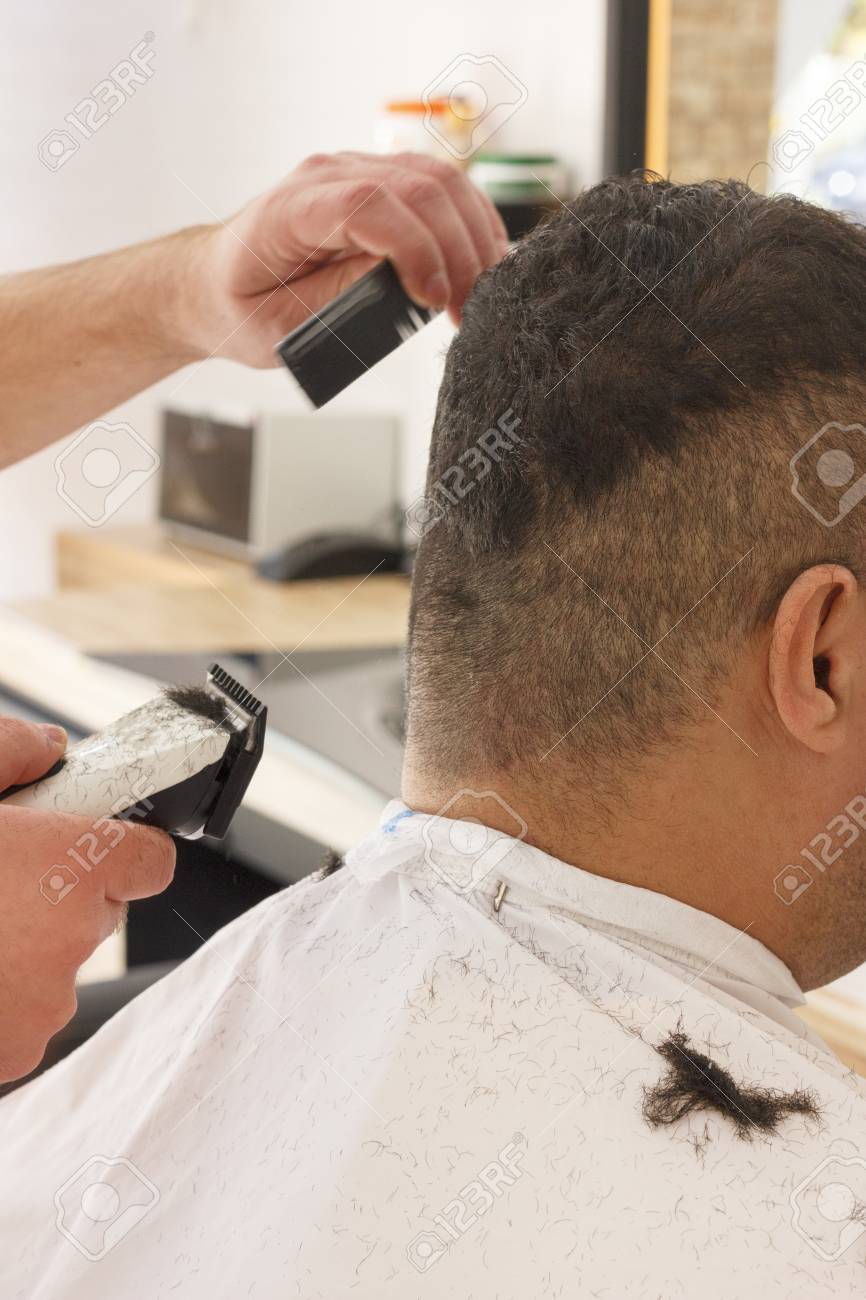 Back View Of Man Getting Short Hair Trimming At Barber Shop With