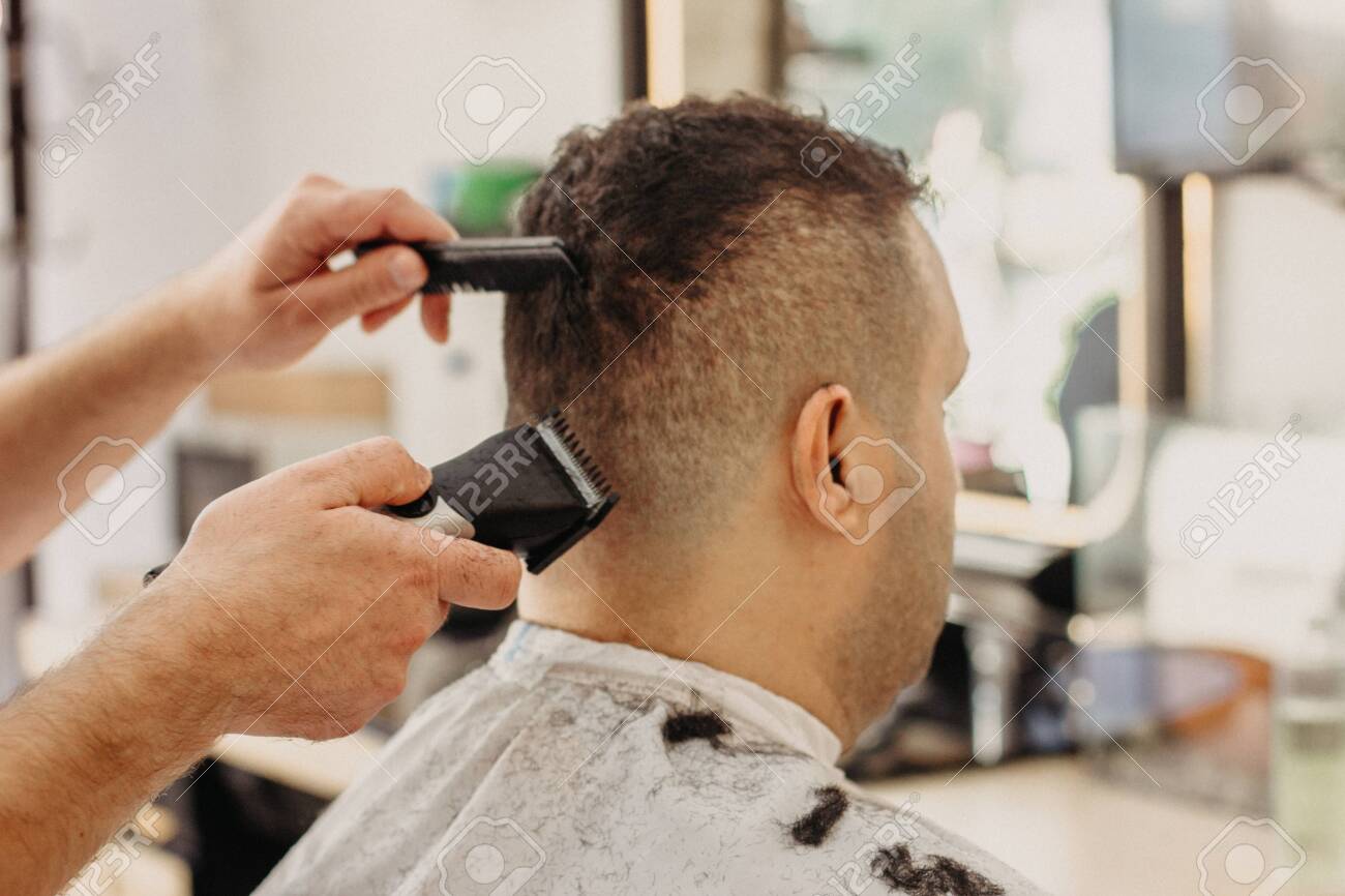Barber Making Stylish Haircut With Professional Machine In Barber