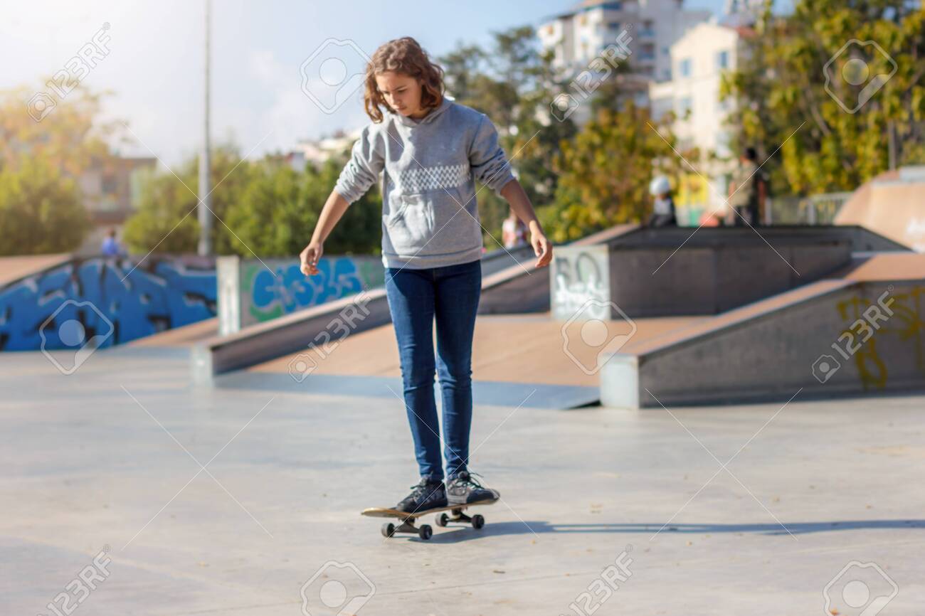 Girl Teenager Rides On A Skateboard 