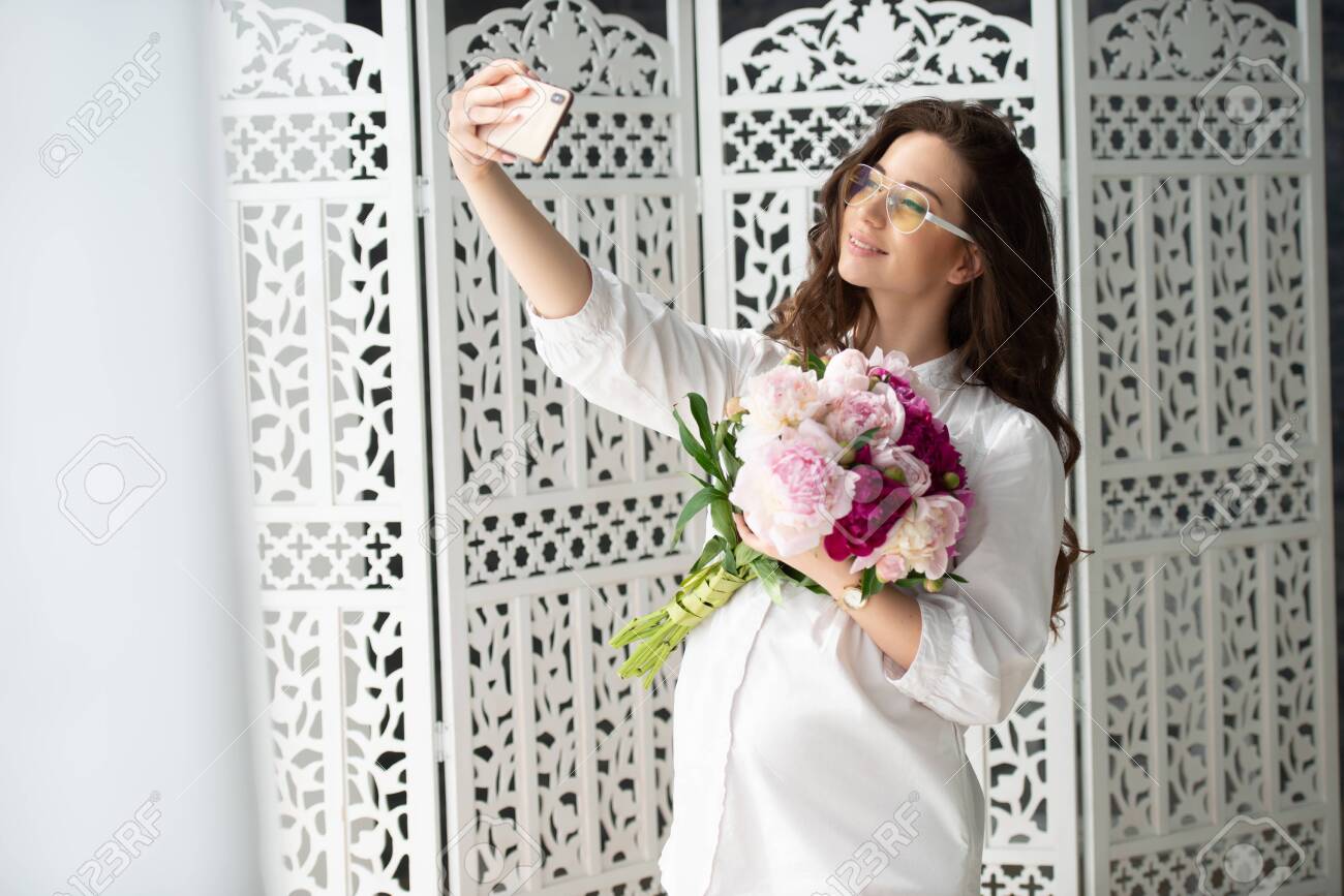Healthy Pregnancy And Happy Motherhood Beautiful Young Pregnant Stock Photo Picture And Royalty Free Image Image 129959094 https www 123rf com photo 129959094 healthy pregnancy and happy motherhood beautiful young pregnant woman with a bouquet of flowers make html