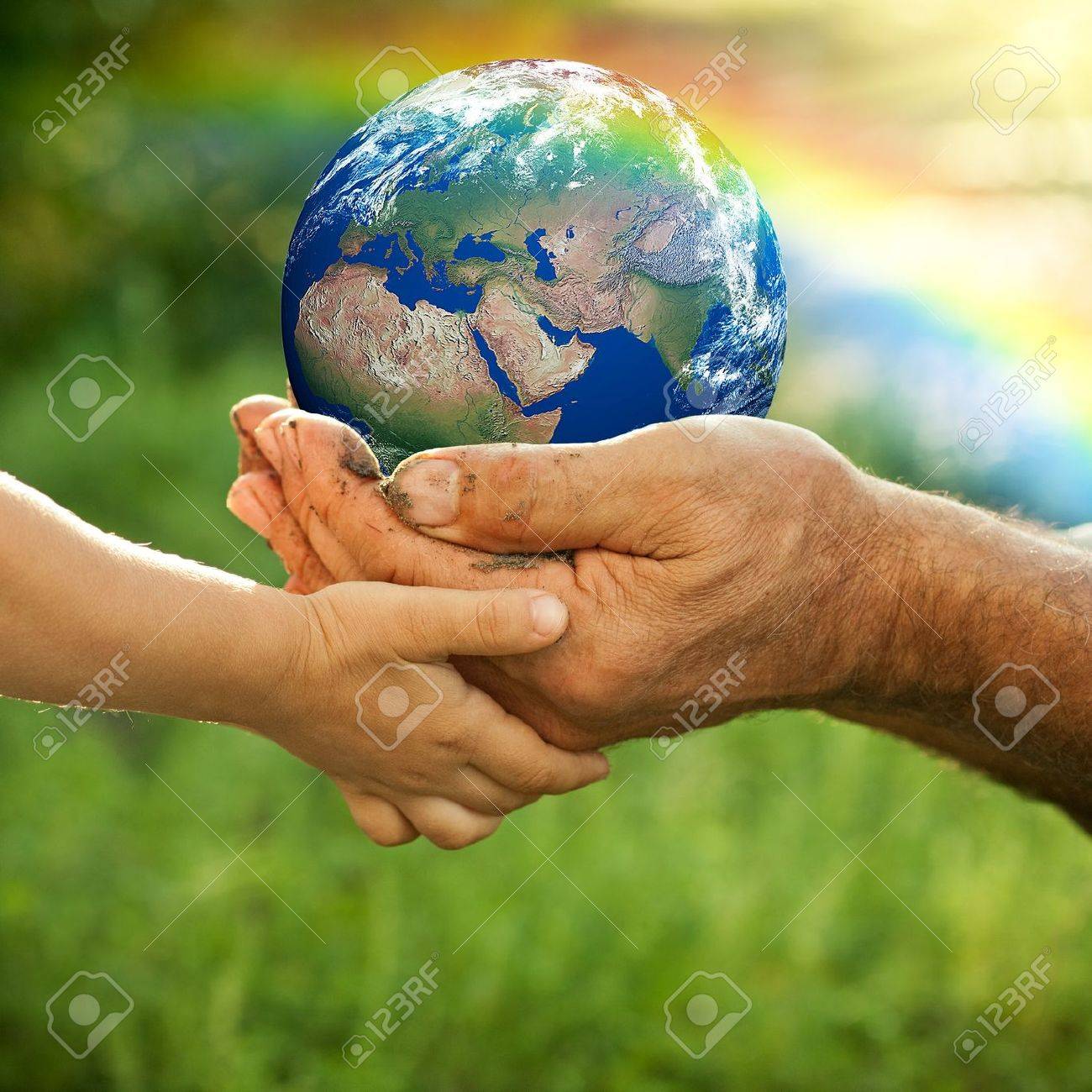 Hands of senior man and baby holding Earth against a rainbow in spring Ecology concept - 12580809 Hands of senior man and baby holding Earth against a rainbow in spring Ecology concept - 12580809