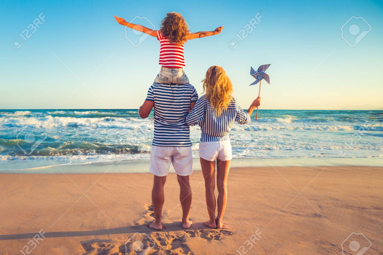 Happy family on the beach. People having fun on summer vacation. Father, mother and child against blue sea and sky background. Holiday travel concept - 78281259 Happy family on the beach. People having fun on summer vacation. Father, mother and child against blue sea and sky background. Holiday travel concept - 78281259
