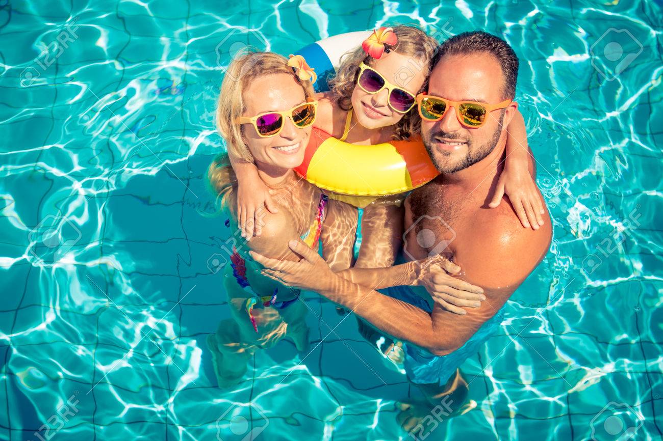 Happy family having fun on summer vacation. Father, mother and child playing in swimming pool. Active healthy lifestyle concept - 78453790 Happy family having fun on summer vacation. Father, mother and child playing in swimming pool. Active healthy lifestyle concept - 78453790