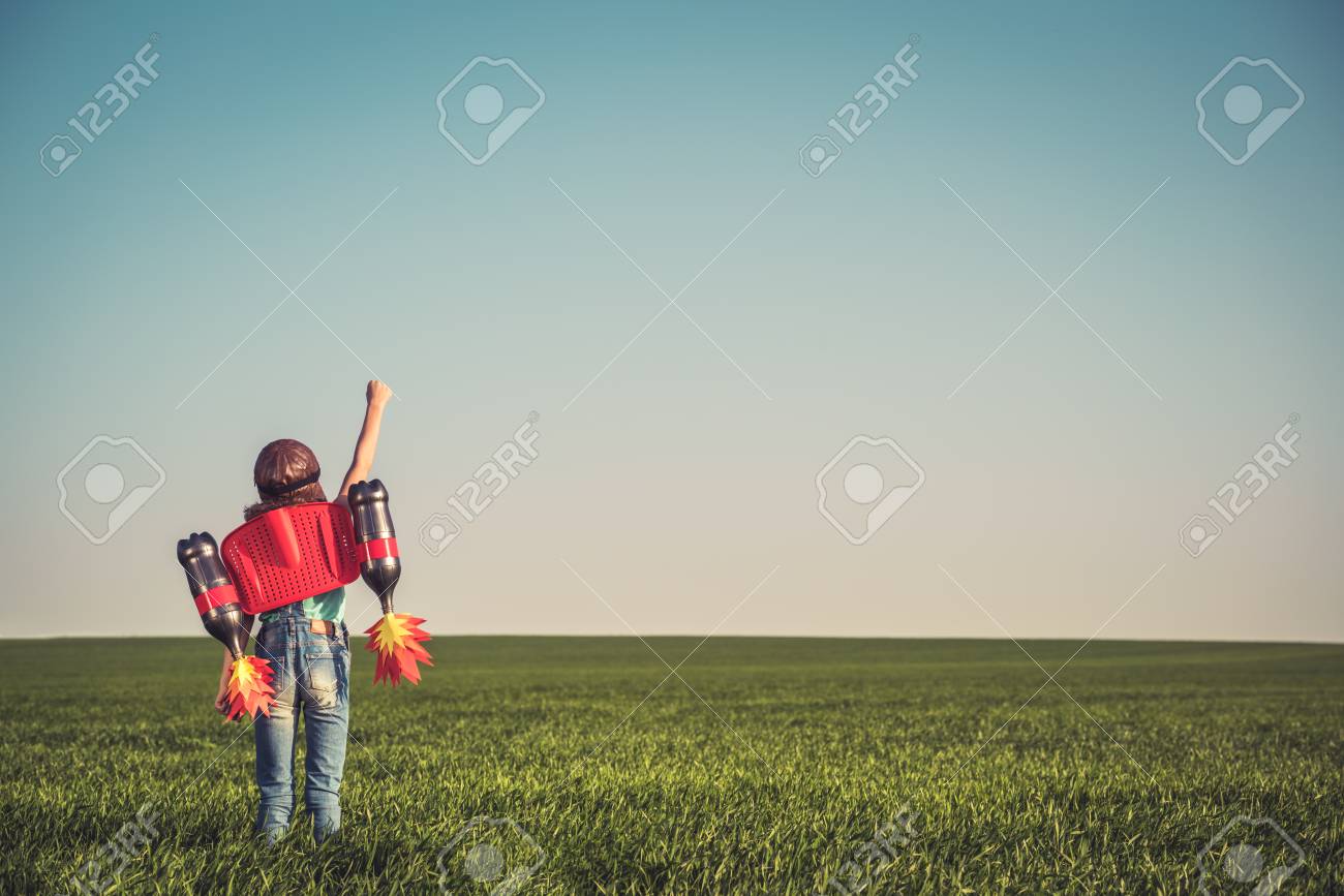 Kid with jet pack outdoor. Child playing in green spring field. Success, imagination and innovation technology concept. Summer travel and adventure - 78755393 Kid with jet pack outdoor. Child playing in green spring field. Success, imagination and innovation technology concept. Summer travel and adventure - 78755393
