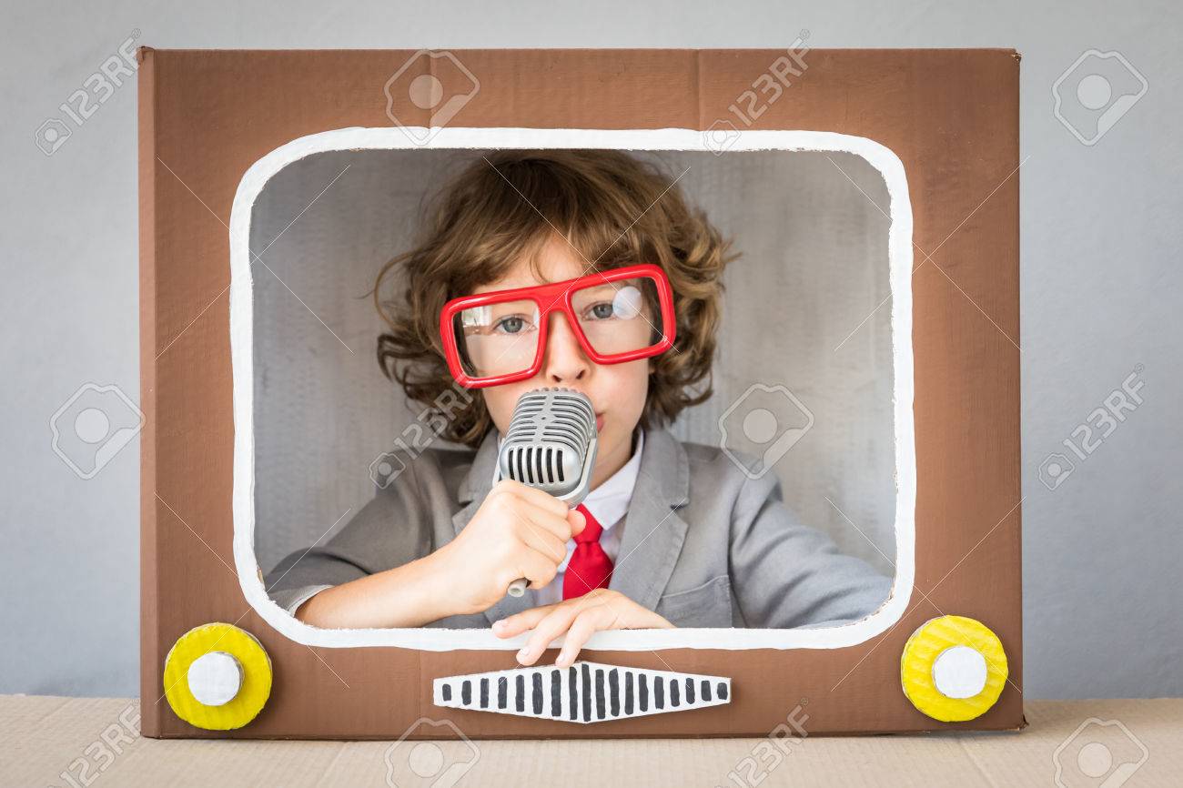 Child playing with cardboard box TV. Kid having fun at home. Communication concept - 83655731 Child playing with cardboard box TV. Kid having fun at home. Communication concept - 83655731