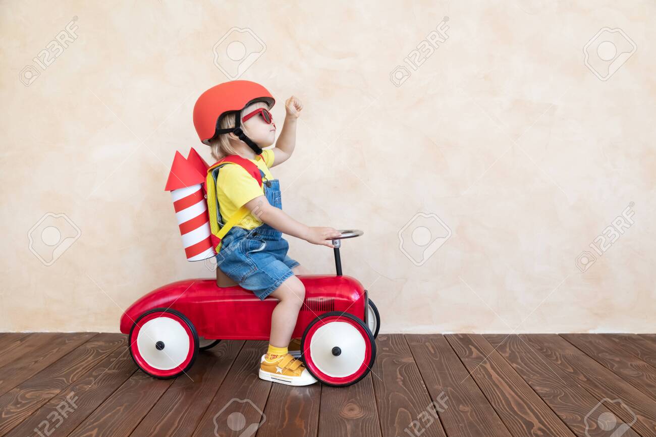Kid with toy paper rocket. Child playing at home. Success, imagination and innovation technology concept - 122555634 Kid with toy paper rocket. Child playing at home. Success, imagination and innovation technology concept - 122555634