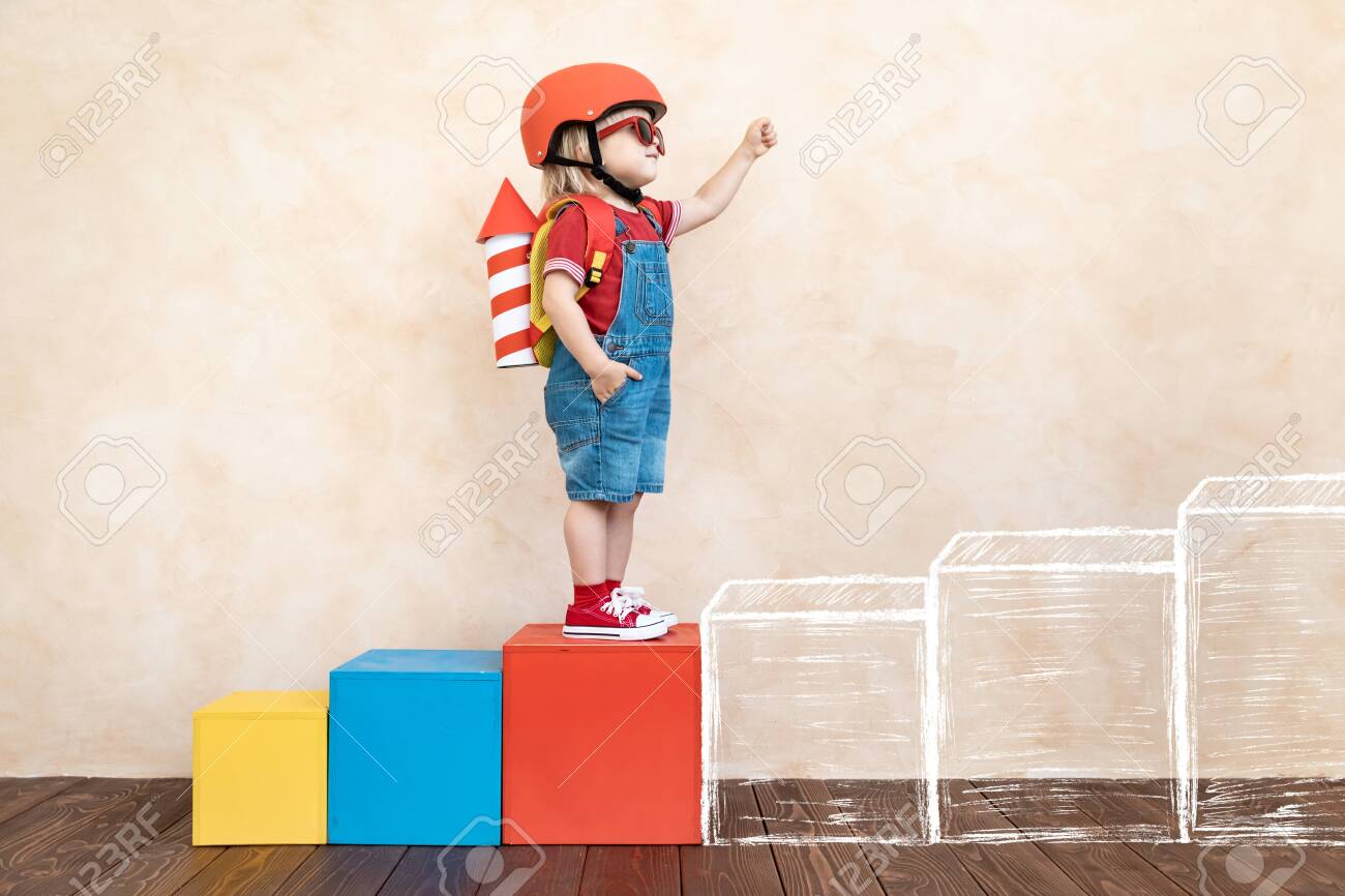 Kid with toy paper rocket. Child playing at home. Success, imagination and innovation technology concept - 126941297 Kid with toy paper rocket. Child playing at home. Success, imagination and innovation technology concept - 126941297