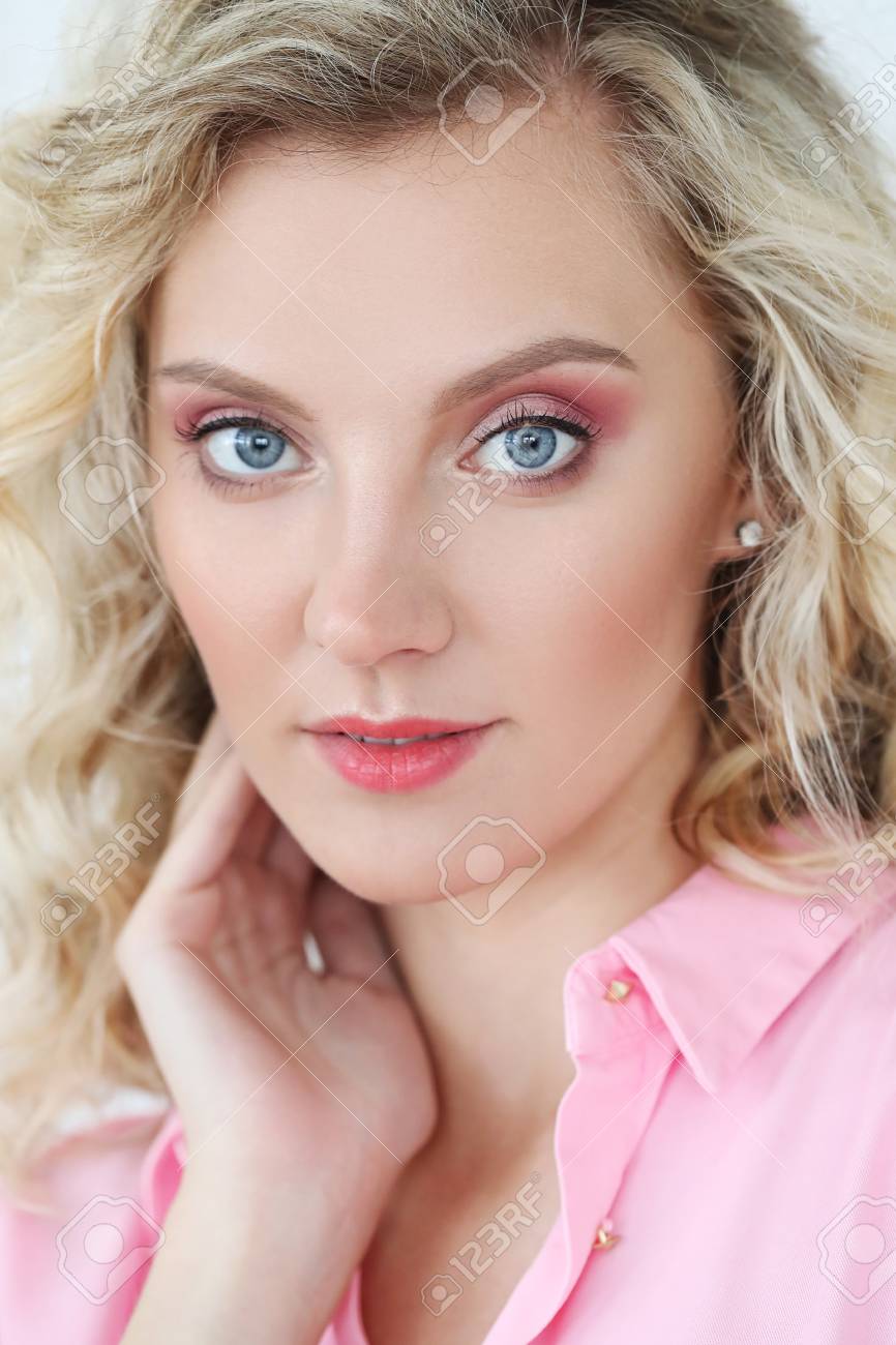 Lovely Girl With Blue Eyes And Curly Hairstyle Stock Photo