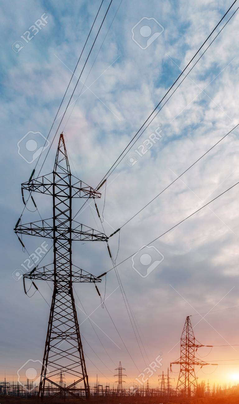 high voltage power lines at sunset electricity distribution station