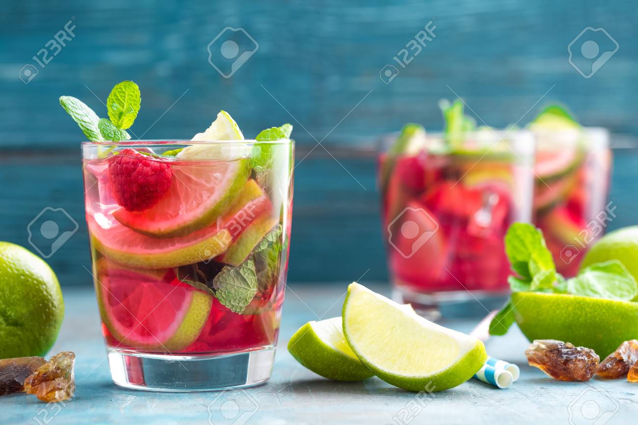 refreshing mint cocktail mojito with rum lime and raspberry