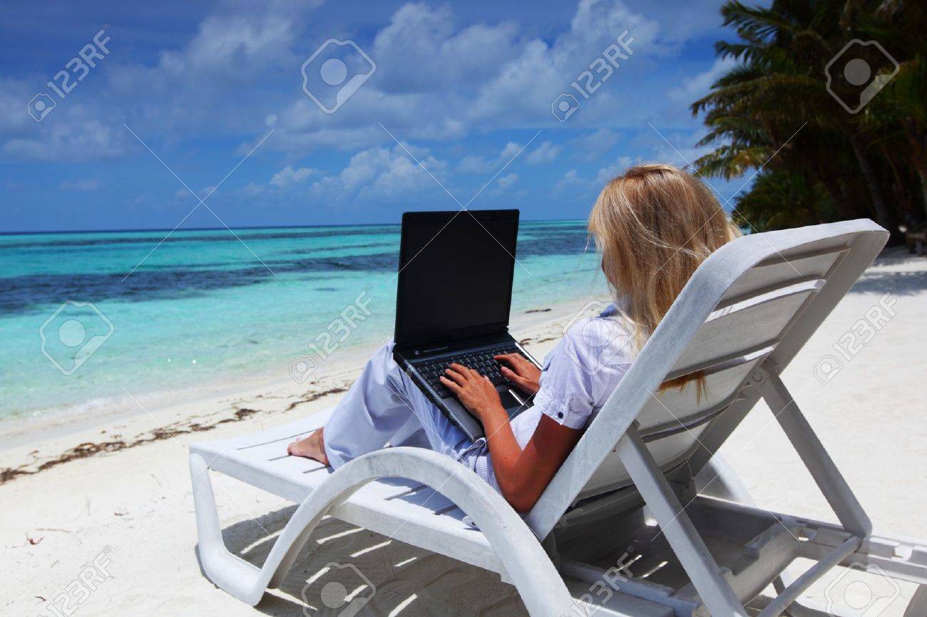 business woman with laptop lying on a chaise lounge in the tropical ocean coast - 11031635 business woman with laptop lying on a chaise lounge in the tropical ocean coast - 11031635
