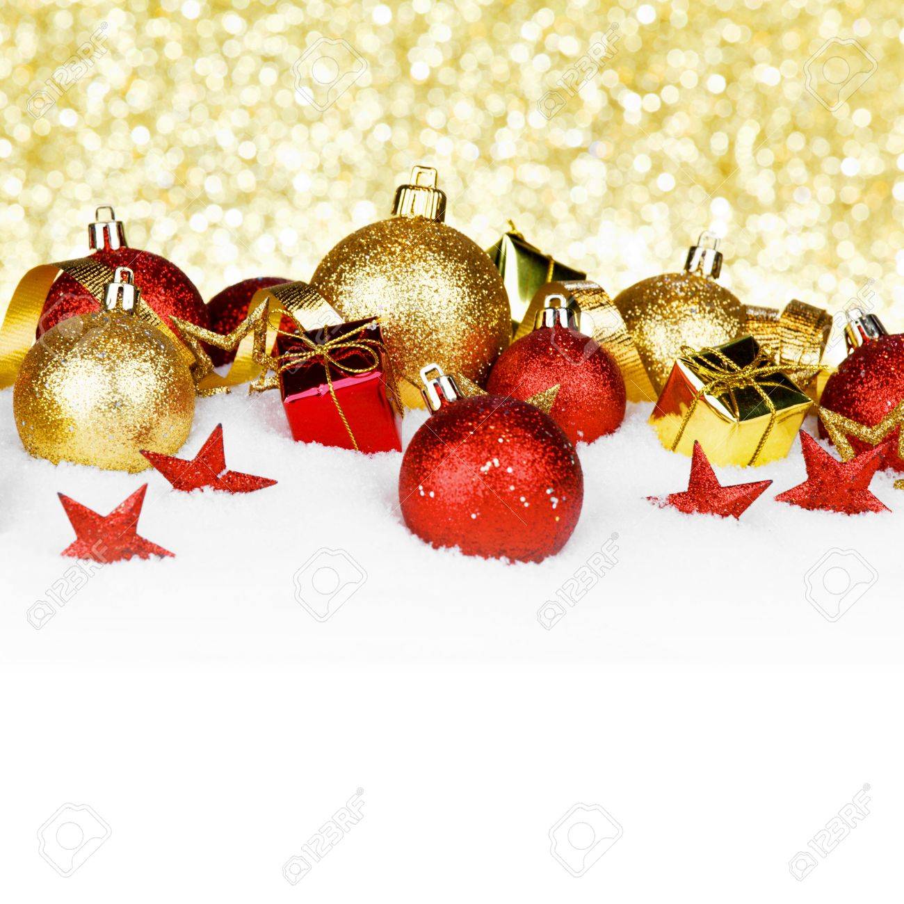 christmas card with colorful decorations in snow on gold background