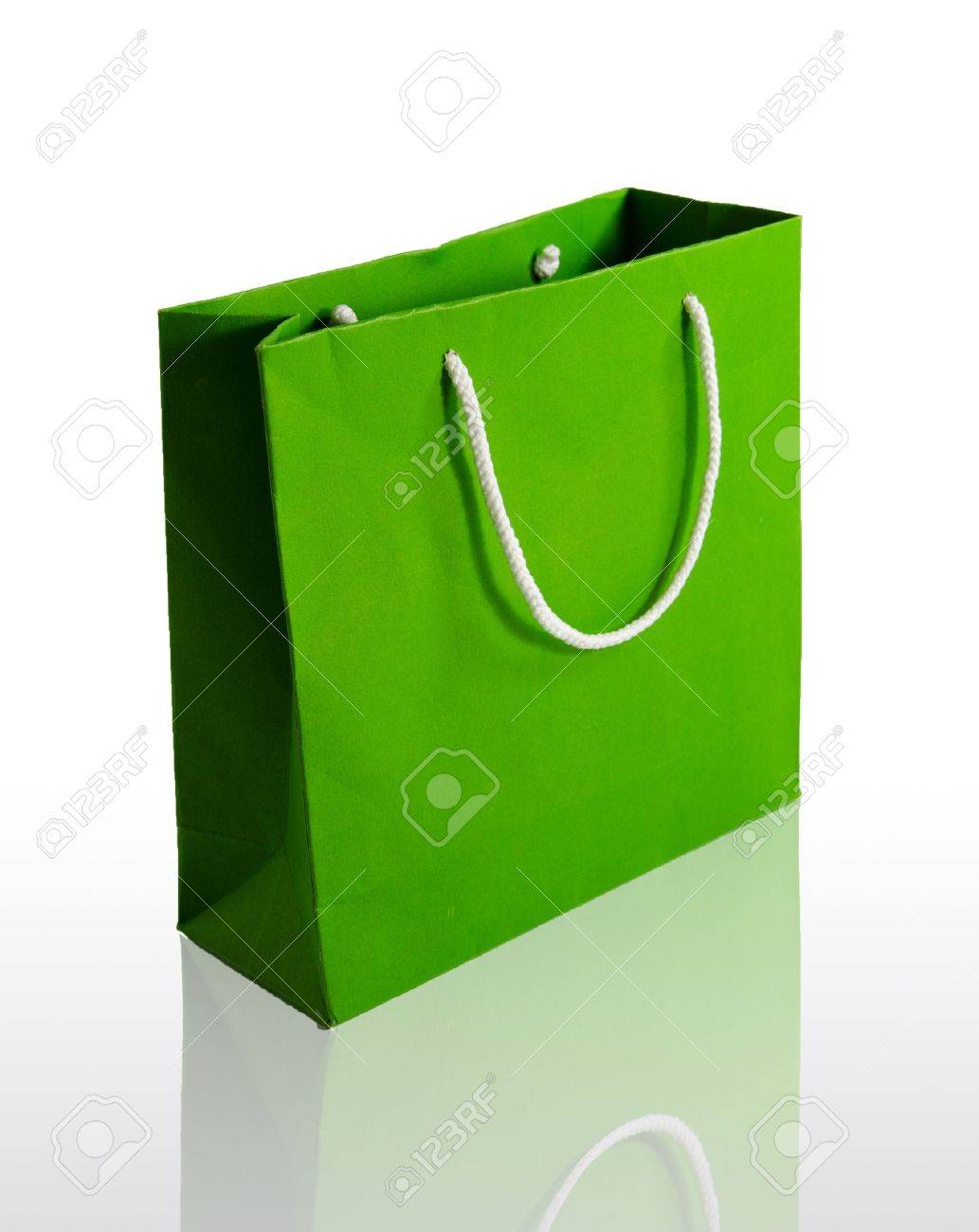 Green paper bag on reflect floor and white background - 11133177 Green paper bag on reflect floor and white background - 11133177