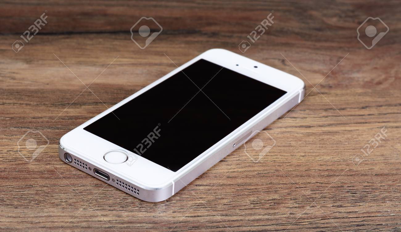 Minsk, Belarus - April 16, 2016: Apple IPhone 5, 5S. White Version. Front  View. The Operating System IOS 9. The Founders Of The Company: Steve Jobs,  Ronald Wayne, Steve Wozniak. Apple Inc., image size:1300x752