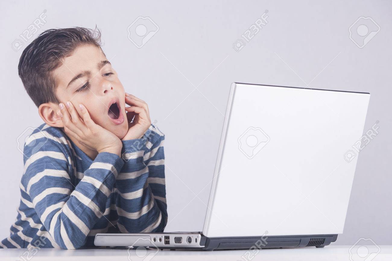 little boy is bored while using a computer unhealthy lifestyle