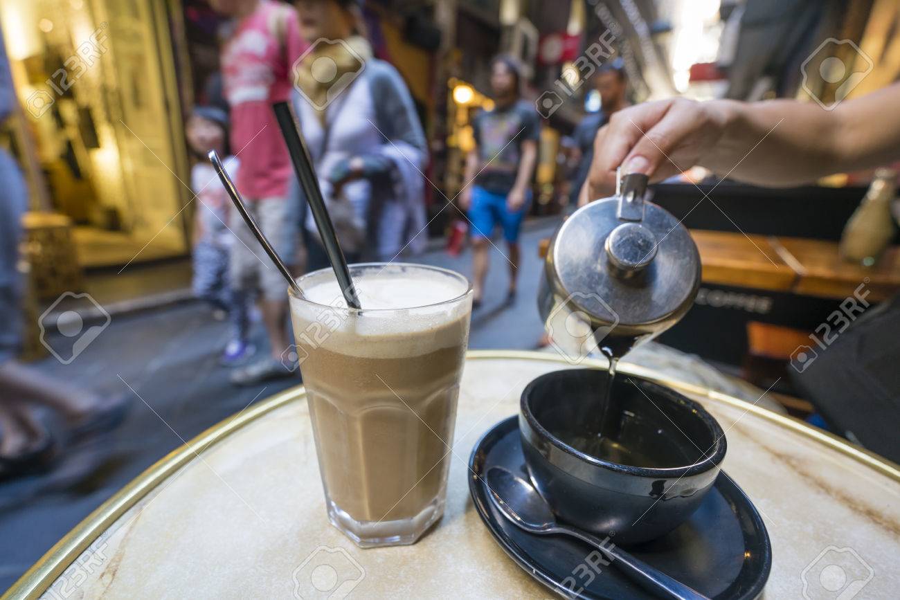 Enjoying coffee and tea at a cafe in a laneway, shallow depth of view - 50881370 Enjoying coffee and tea at a cafe in a laneway, shallow depth of view - 50881370
