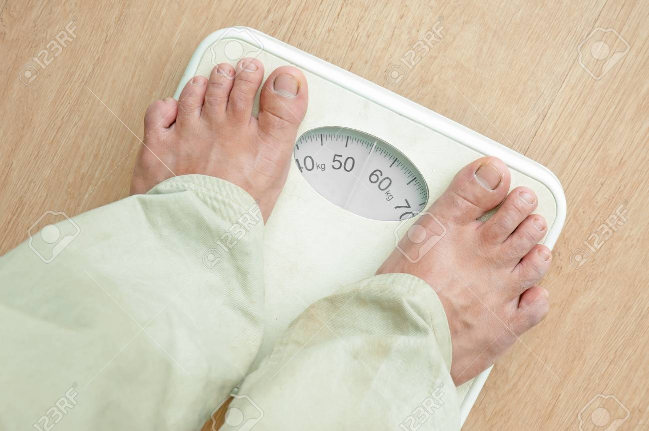 Man Standing On Weight Scales With Bare Foot Stock P O 21303738 Man Standing On Weight Scales With Bare Foot Stock P O 21303738