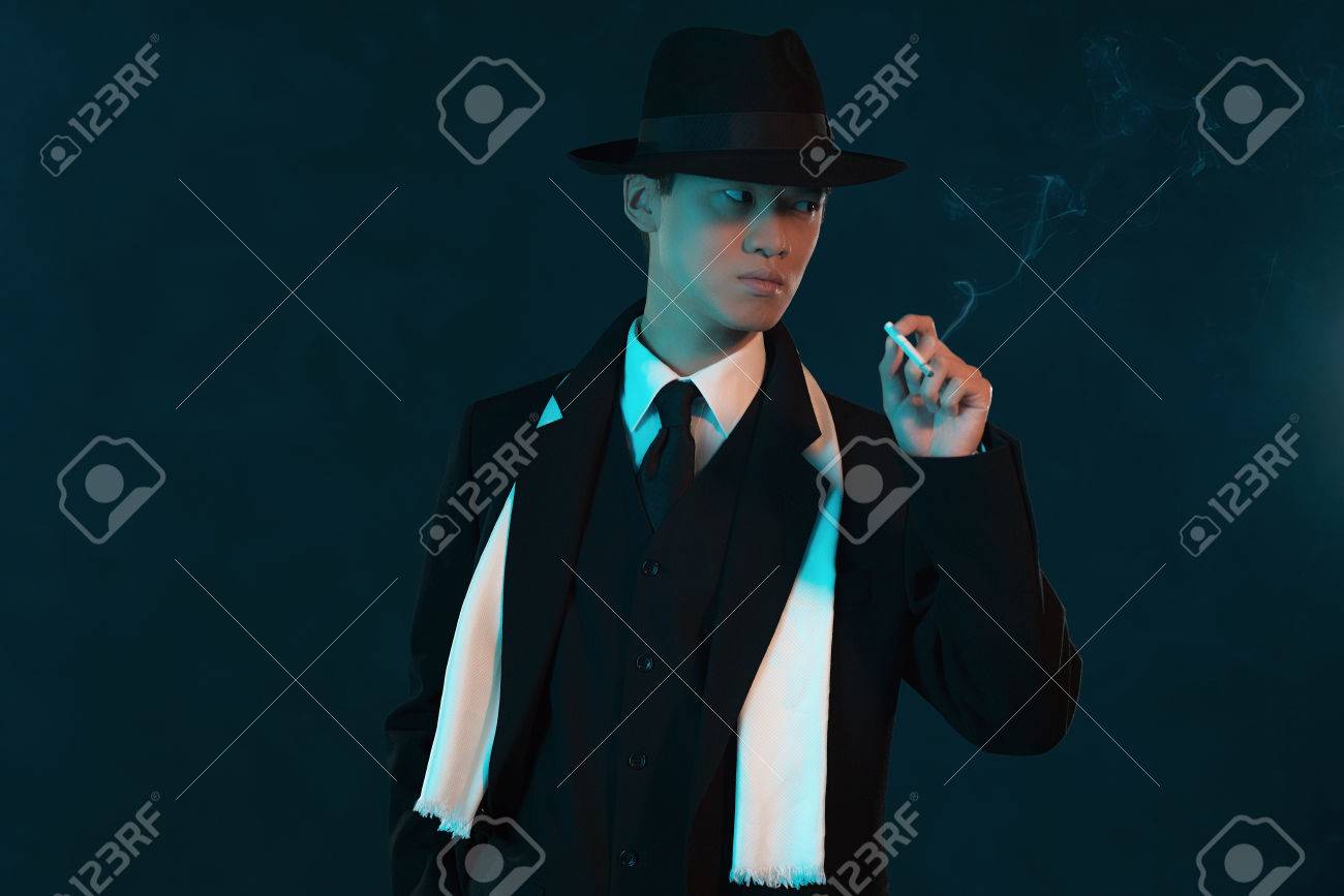 retro 1940 asian gangster fashion man holding cigarette stock