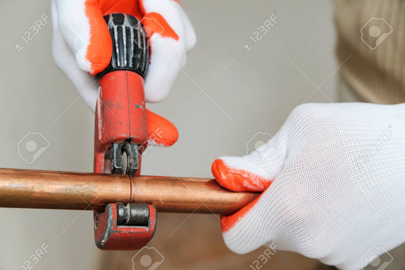 The Worker Is Using A Copper Pipe Cutter To Cut The Pipes Of The Desired Size Stock Photo Picture And Royalty Free Image Image 92760812