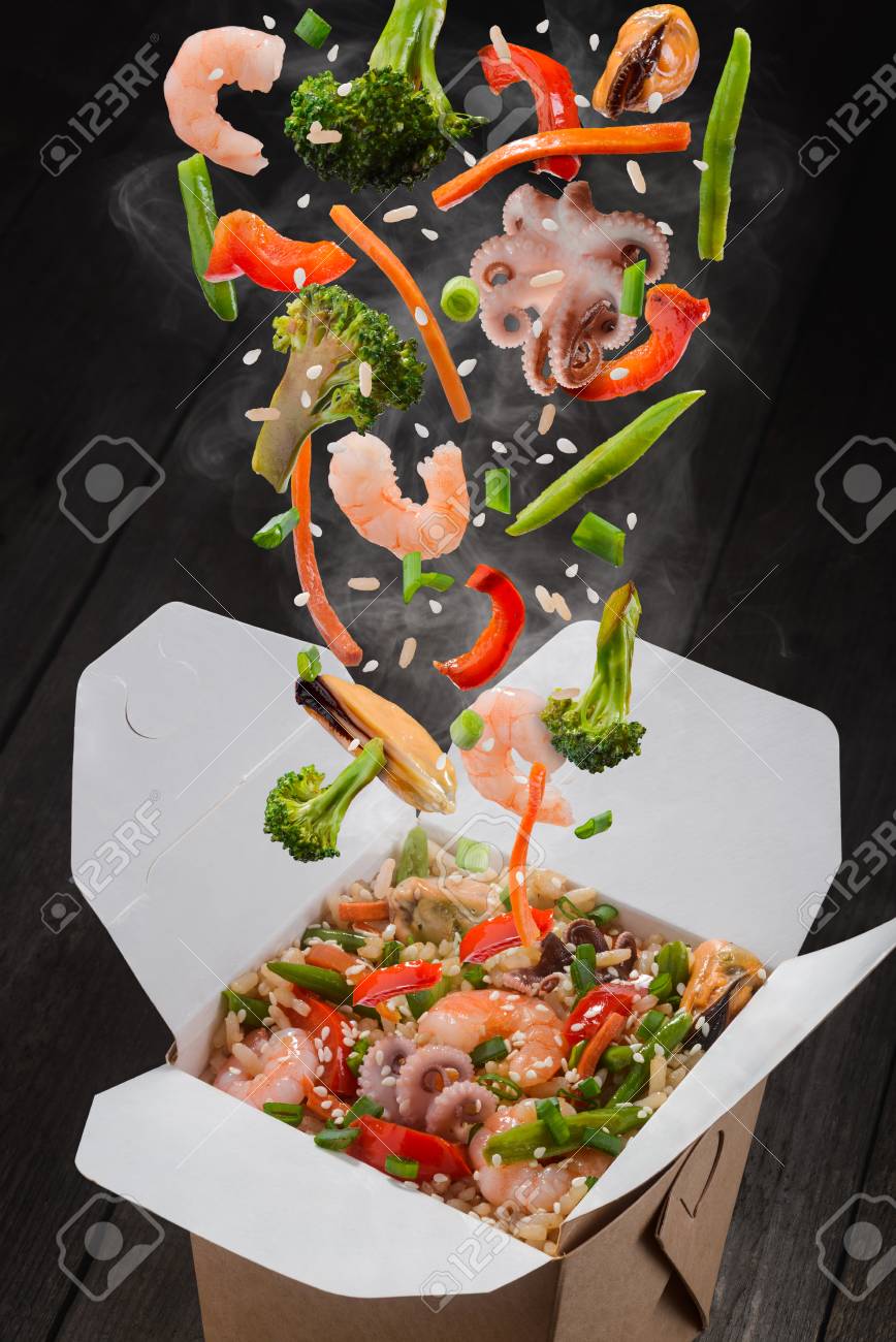 Rice with vegetables and seafood. Ingredients such as octopuses, mussels, shrimps, broccoli, pepper, lettuce, asparagus, rice and sesame seeds falling in take-out box. - 106266442 Rice with vegetables and seafood. Ingredients such as octopuses, mussels, shrimps, broccoli, pepper, lettuce, asparagus, rice and sesame seeds falling in take-out box. - 106266442
