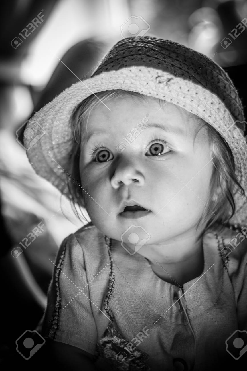 Un Bebe Mignon Lumiere Du Soleil Sur Le Visage De L Enfant Un Regard Curieux D Une Petite Fille Triste Regard De L Enfant Il Regarde Attentivement Un Enfant Dans Un Chapeau De Paille Enfance
