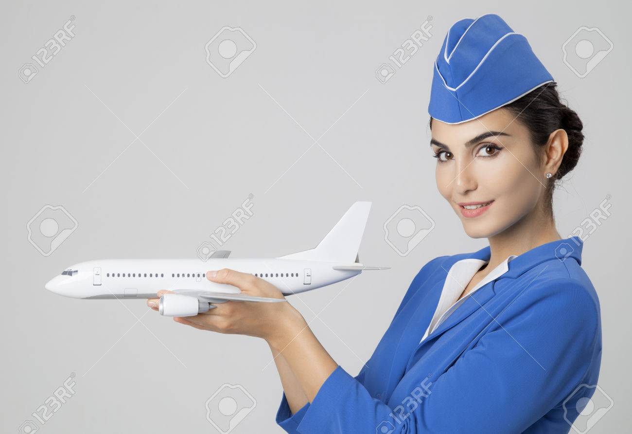 Charming Stewardess Holding Airplane In Hand. - 32514531 Charming Stewardess Holding Airplane In Hand. - 32514531