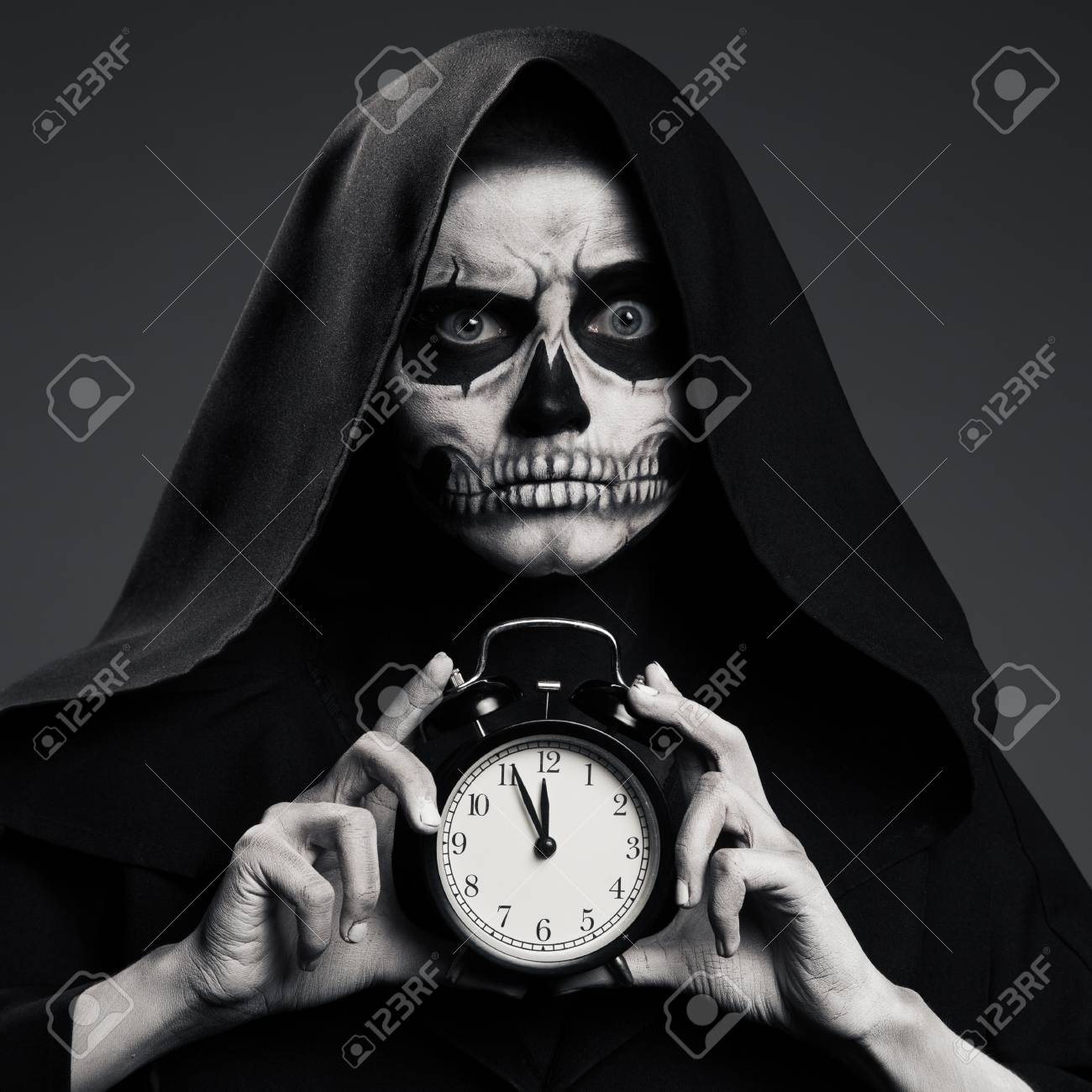 怖い死は 彼の手で時計を保持します リアルなスカルのメイク の写真素材 画像素材 Image