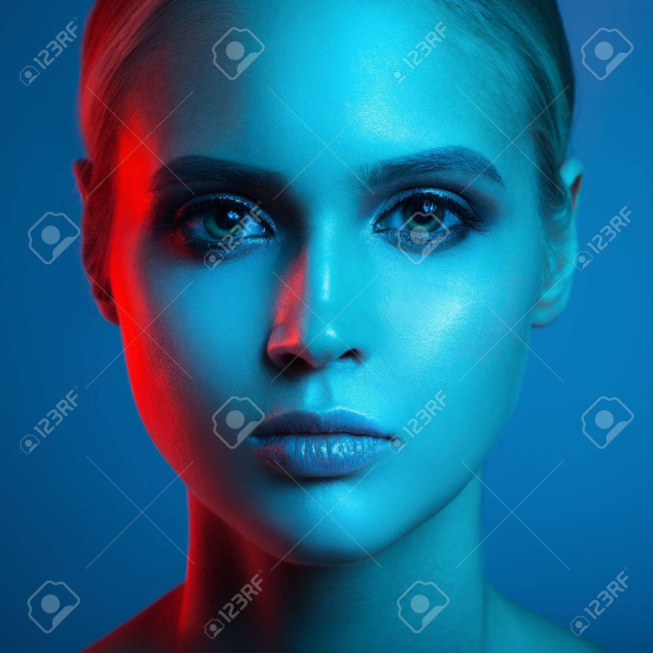 Fashion art portrait of beautiful woman face. Red and blue light color. - 75170724 Fashion art portrait of beautiful woman face. Red and blue light color. - 75170724