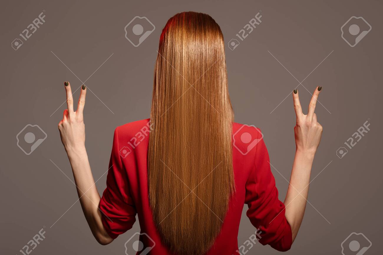 Rear view of beautiful woman with red long hair. - 130779079 Rear view of beautiful woman with red long hair. - 130779079