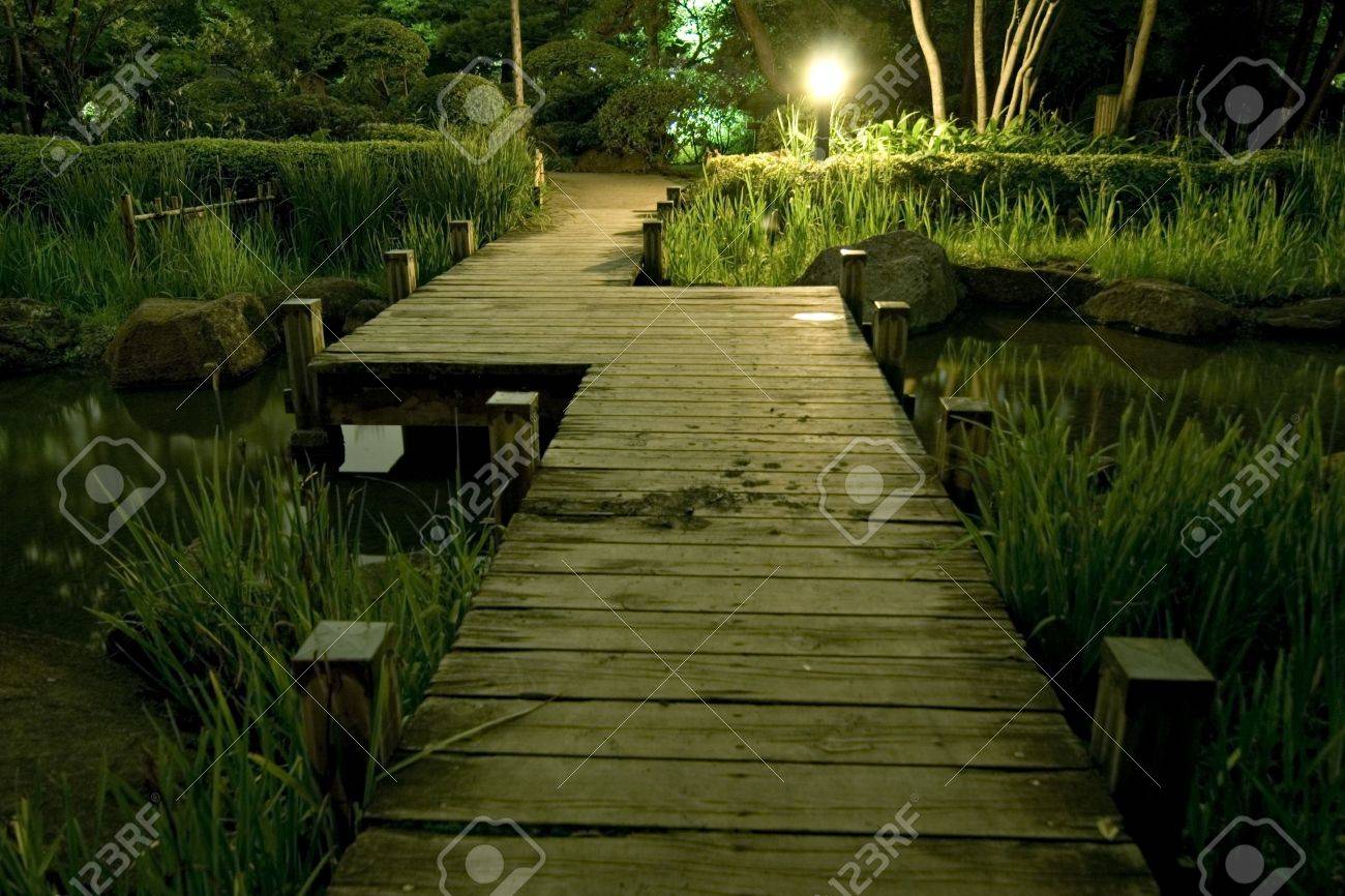 Japanese Garden At Night wooden bridge in japanese garden at night stock photo, picture and Japanese Garden At Night wooden bridge in japanese garden at night stock photo, picture and