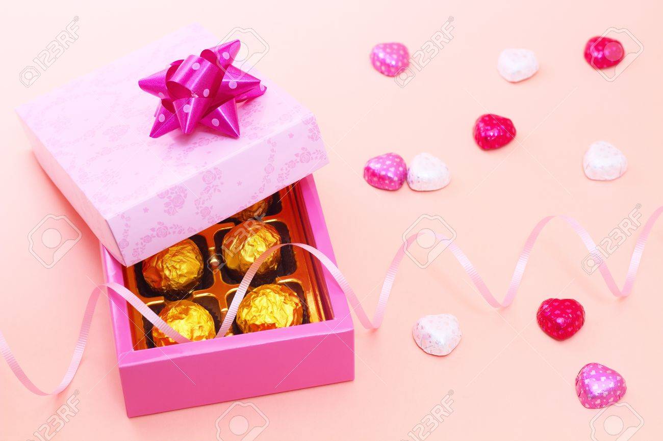 chocolates in a cute gift box with heart candies stock photo